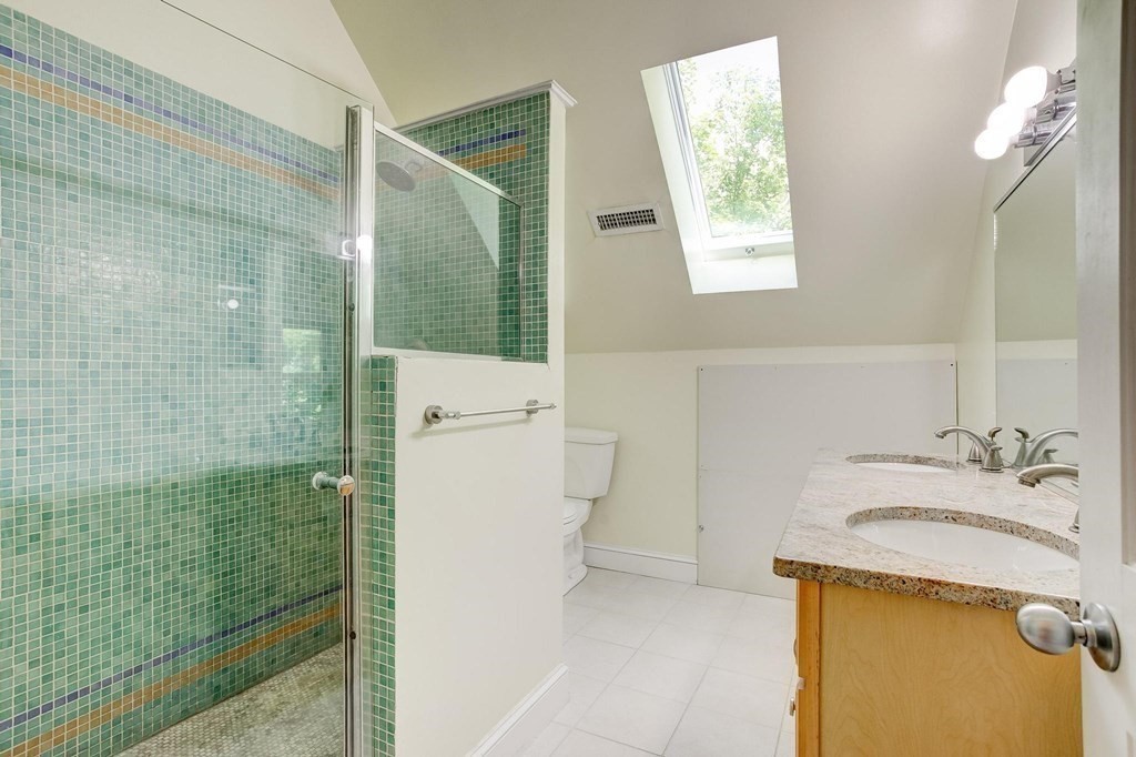 59 Creighton Street, Unit 2 Cambridge, MA 02140 - Photo 34 of 38 a bathroom with a granite countertop sink a toilet and shower