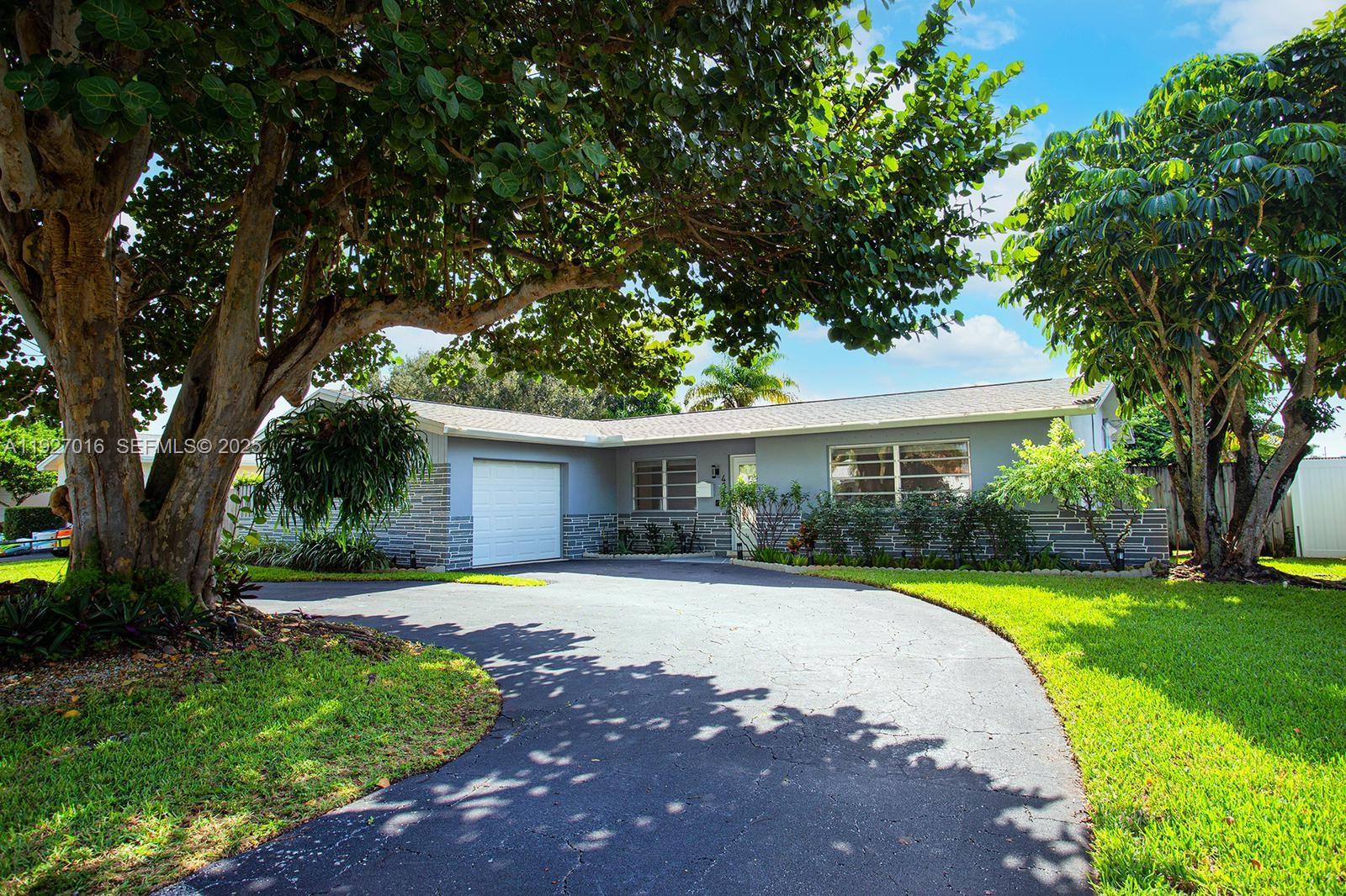 4316 Jackson Street Hollywood, FL 33021 - Photo 1 of 31 a view of a house with a yard and tree