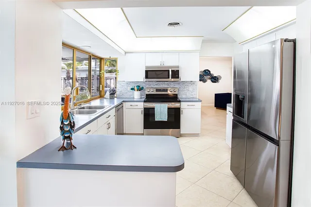 a kitchen with a sink appliances and cabinets