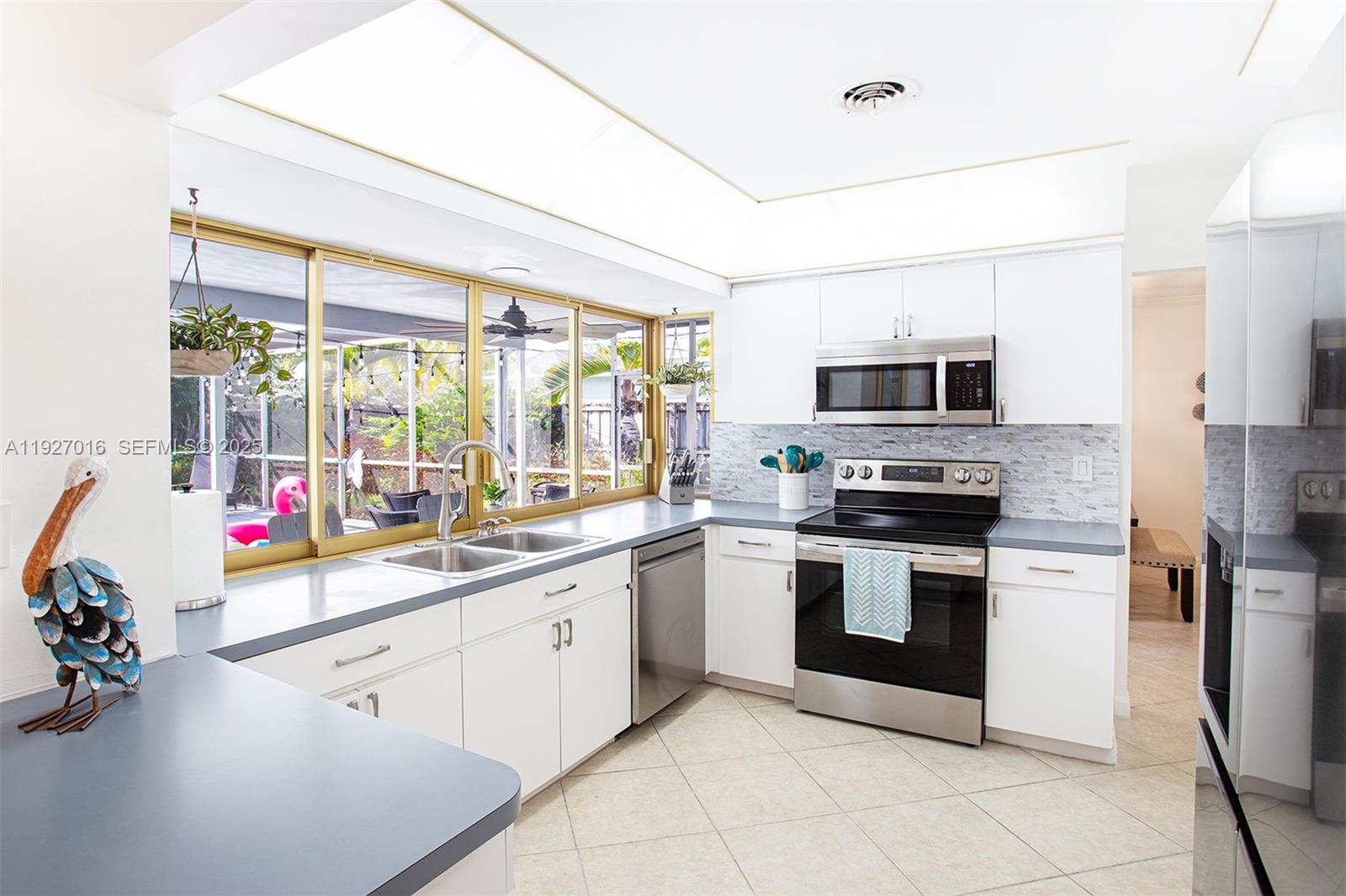 4316 Jackson Street Hollywood, FL 33021 - Photo 16 of 31 a kitchen with a sink appliances and cabinets