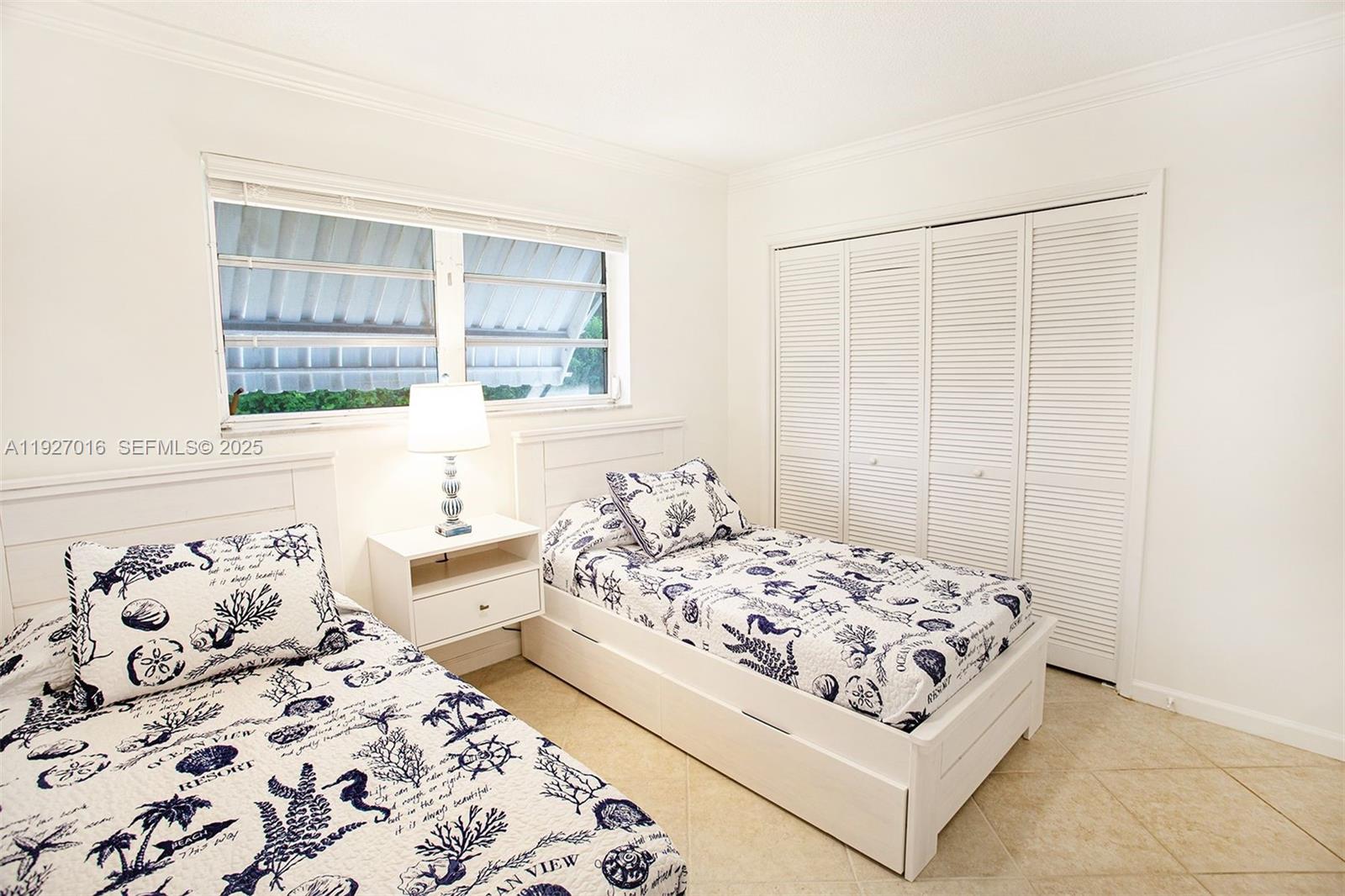 4316 Jackson Street Hollywood, FL 33021 - Photo 18 of 31 a bedroom with a bed and a window