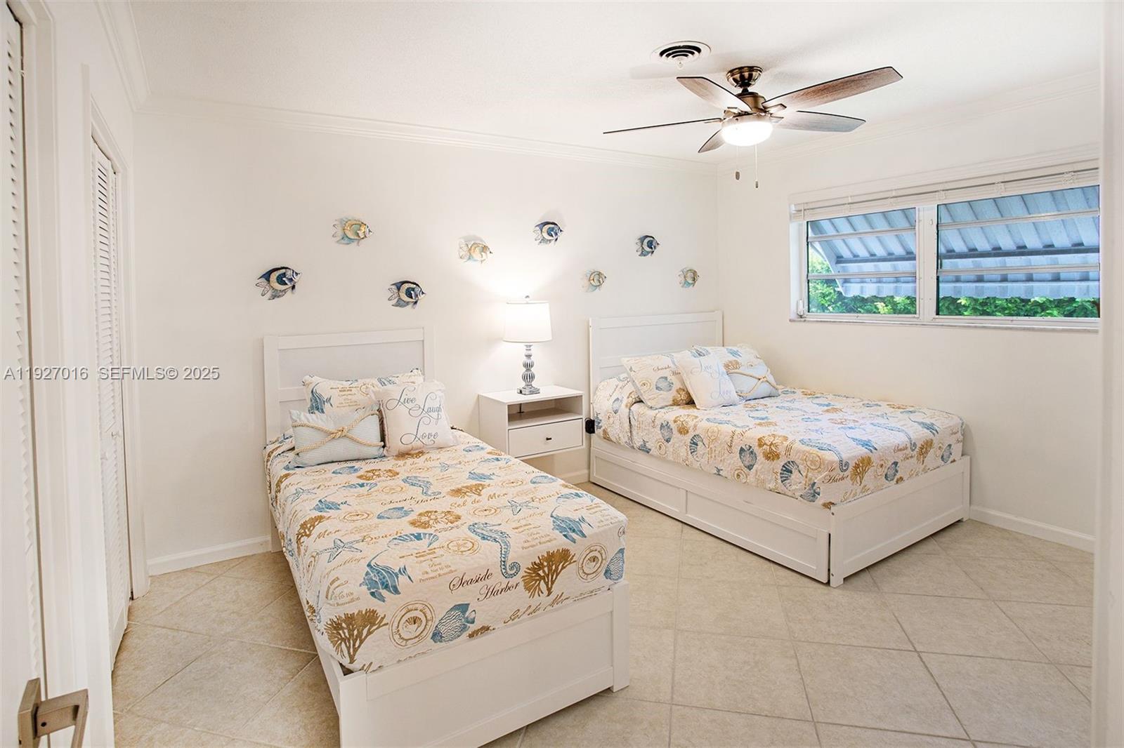 4316 Jackson Street Hollywood, FL 33021 - Photo 19 of 31 a bedroom with a bed and a chandelier