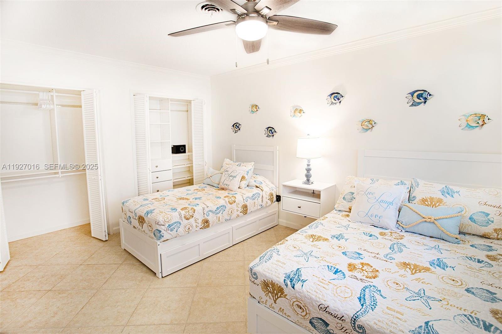 4316 Jackson Street Hollywood, FL 33021 - Photo 20 of 31 a bedroom with two beds and a chandelier