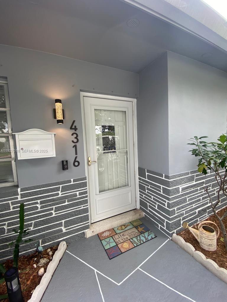 4316 Jackson Street Hollywood, FL 33021 - Photo 3 of 31 a view of room with a couch