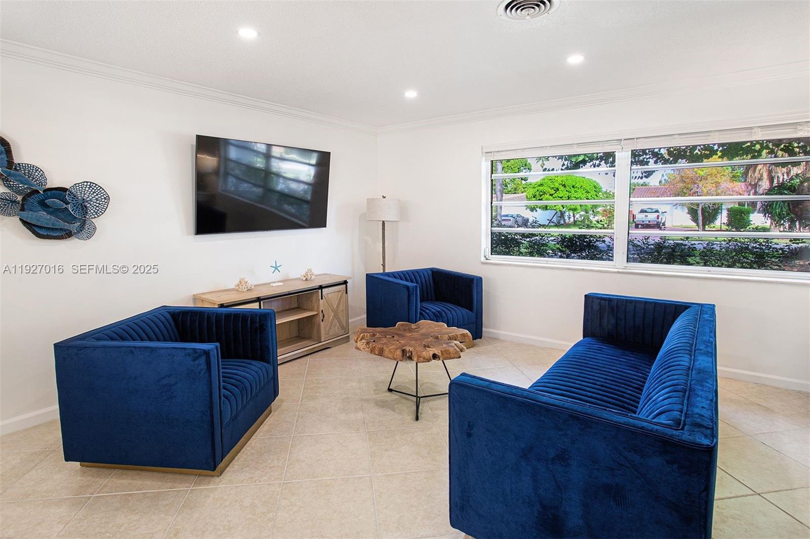 4316 Jackson Street Hollywood, FL 33021 - Photo 7 of 31 a living room with furniture and a flat screen tv