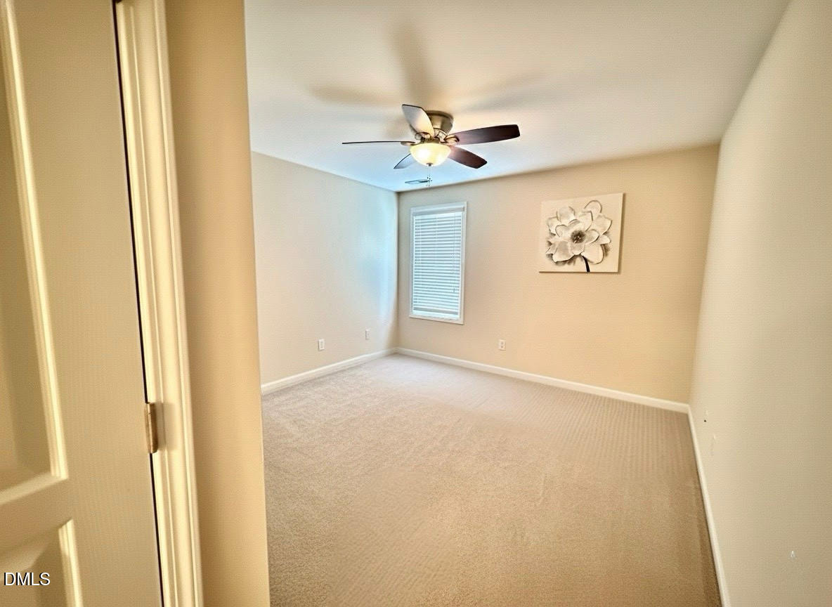 1345 Still Monument Way Raleigh, NC 27603 - Photo 14 of 21 an empty room with windows and ceiling fan