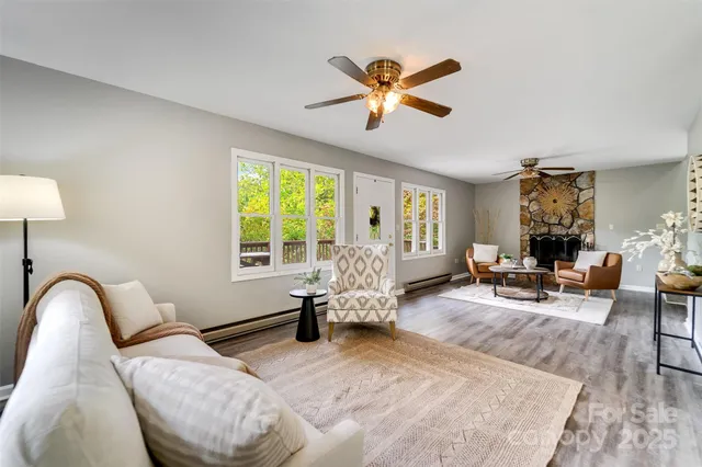 a living room with furniture and wooden floor