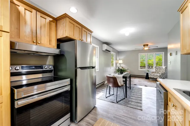 a kitchen with sink refrigerator and dining table