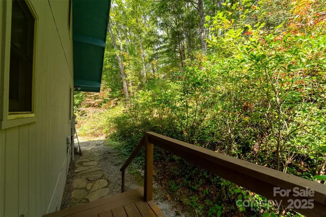 a view of balcony with wooden floor and fence