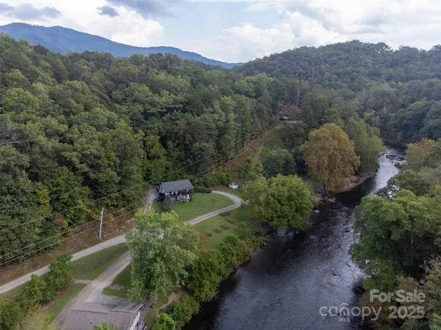 a view of a lush green hillside and a houses
