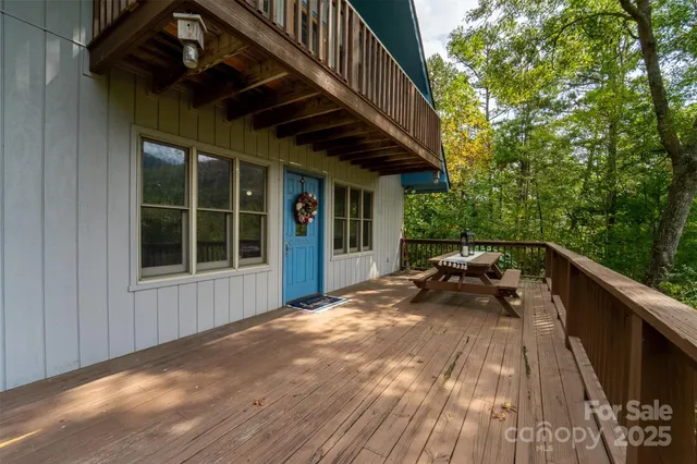 a view of backyard with deck and outdoor seating