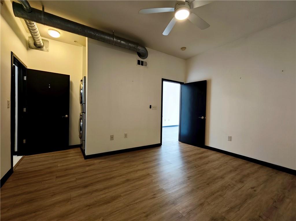 5300 Peachtree Road, Unit 2401 Chamblee, GA 30341 - Photo 12 of 24 a view of an empty room with wooden floor and cabinet