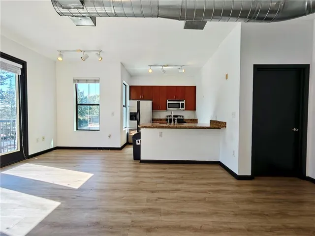 a view of kitchen and living room with a flat screen tv
