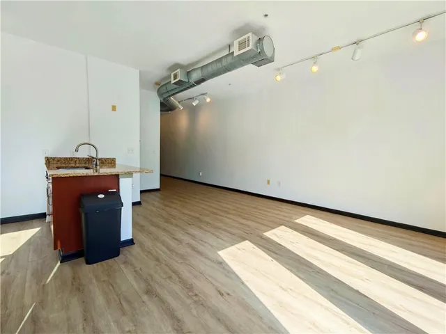 a view of a room with wooden floor