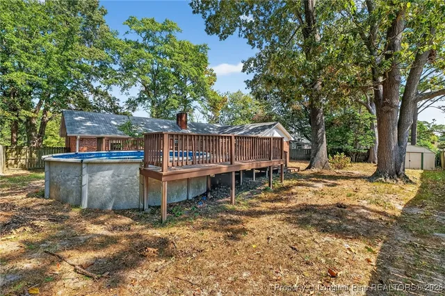 a view of house with swimming pool and porch