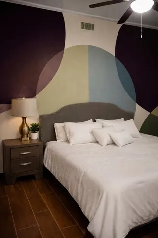 a bed room with a bed and a night stand