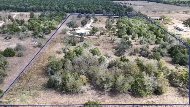 an aerial view of house with yard