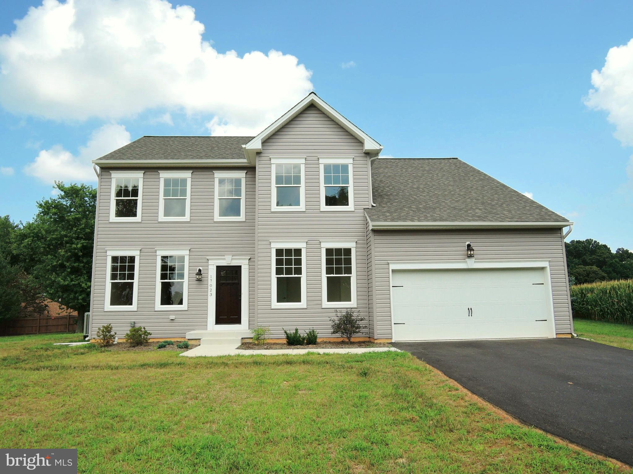 17023 Troyer Road Monkton, MD 21111 - Photo 1 of 30 a front view of a house with a garden and yard