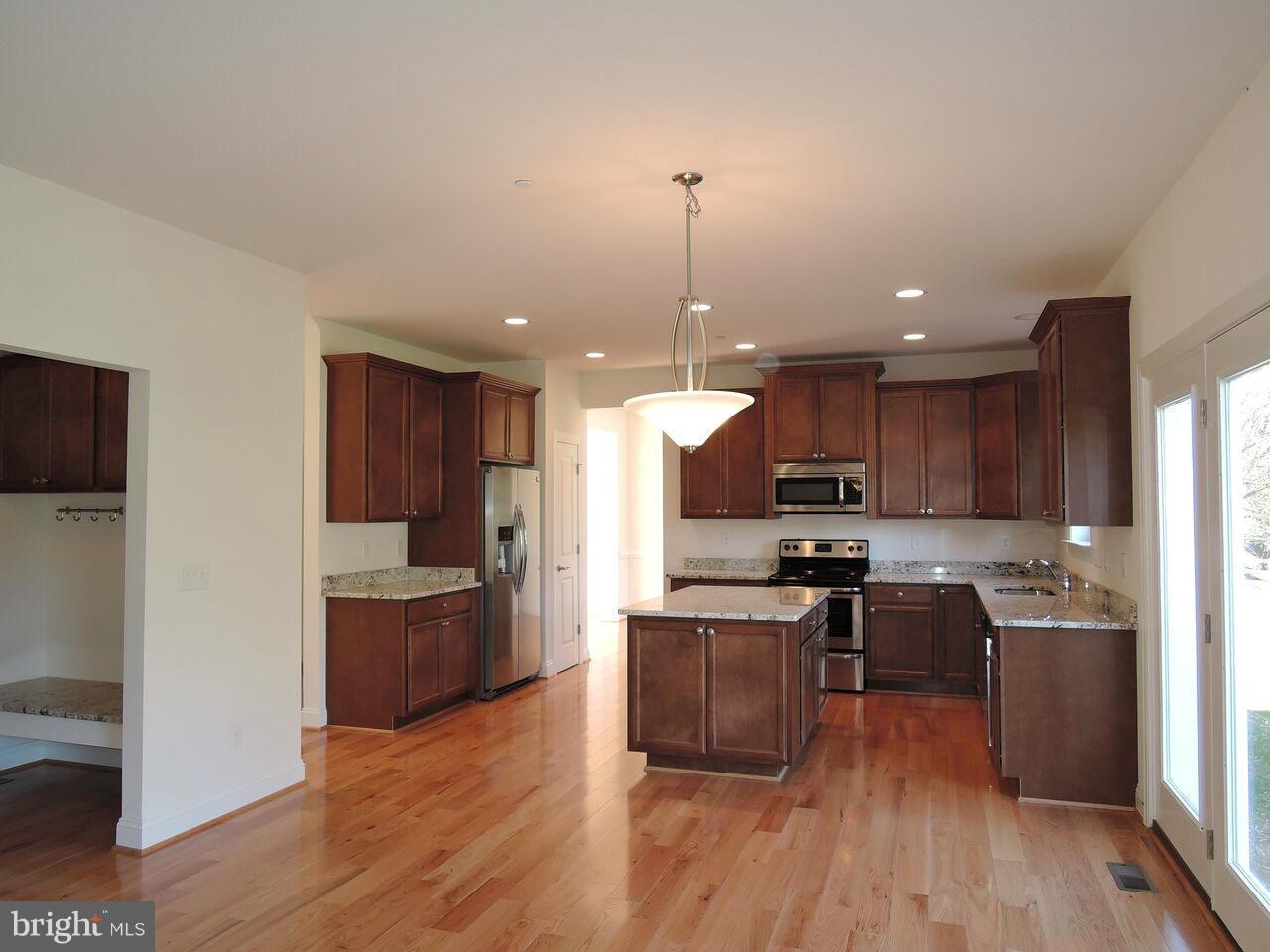 17023 Troyer Road Monkton, MD 21111 - Photo 11 of 30 a kitchen with kitchen island granite countertop a sink cabinets and stainless steel appliances