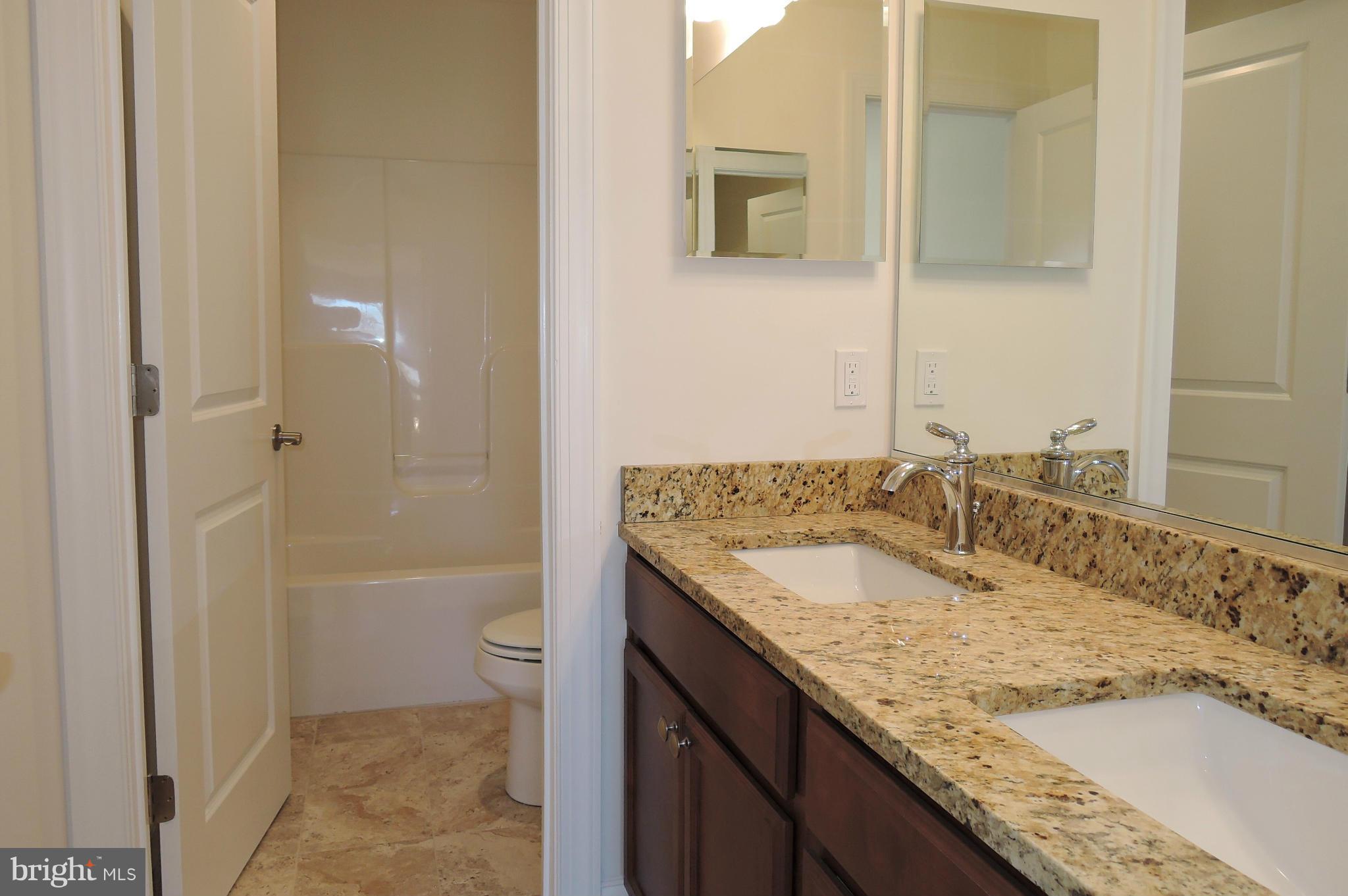 17023 Troyer Road Monkton, MD 21111 - Photo 22 of 30 a bathroom with a granite countertop sink and a mirror