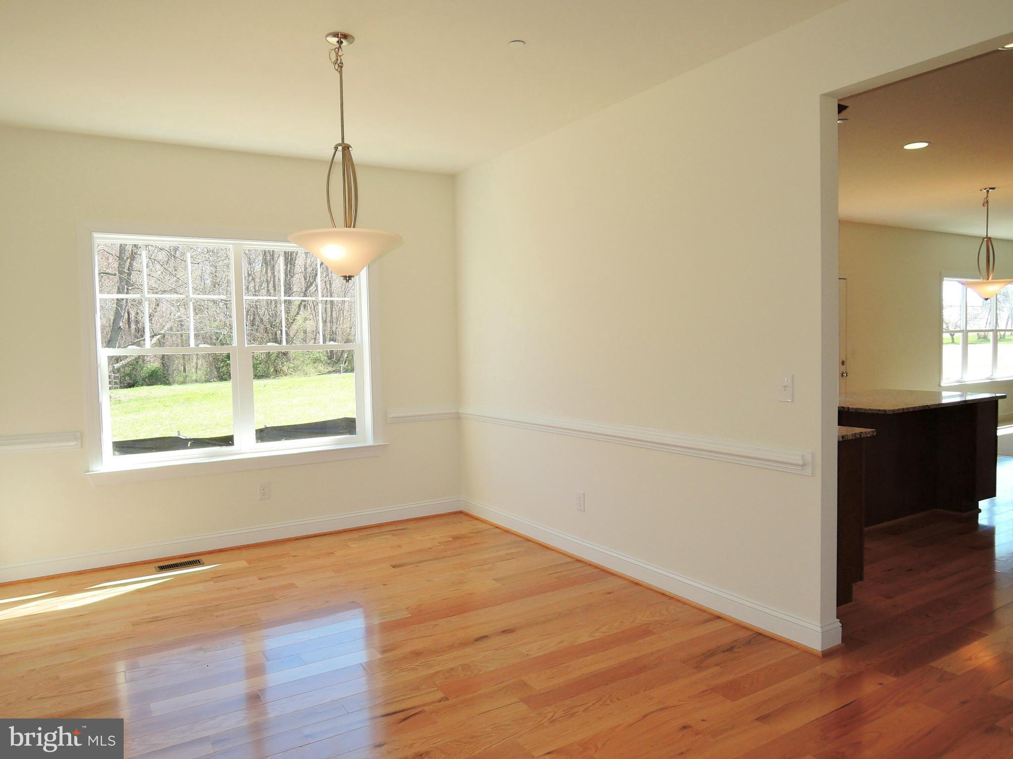 17023 Troyer Road Monkton, MD 21111 - Photo 7 of 30 a view of empty room with wooden floor and fan
