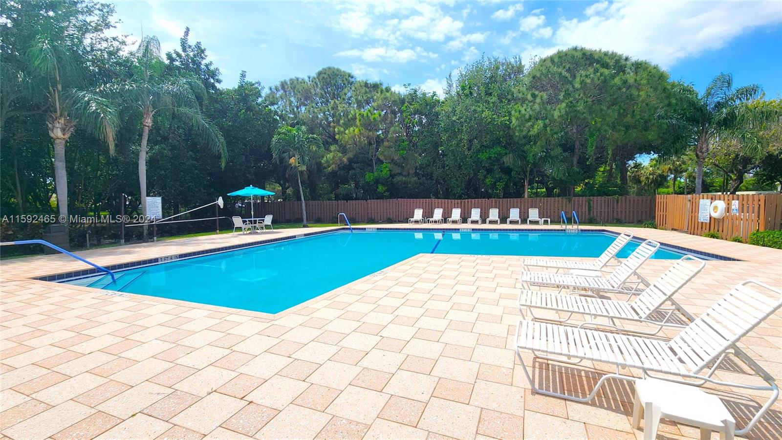 301 Olivewood Place, Unit O229 Boca Raton, FL 33431 - Photo 16 of 25 a view of a swimming pool with a yard