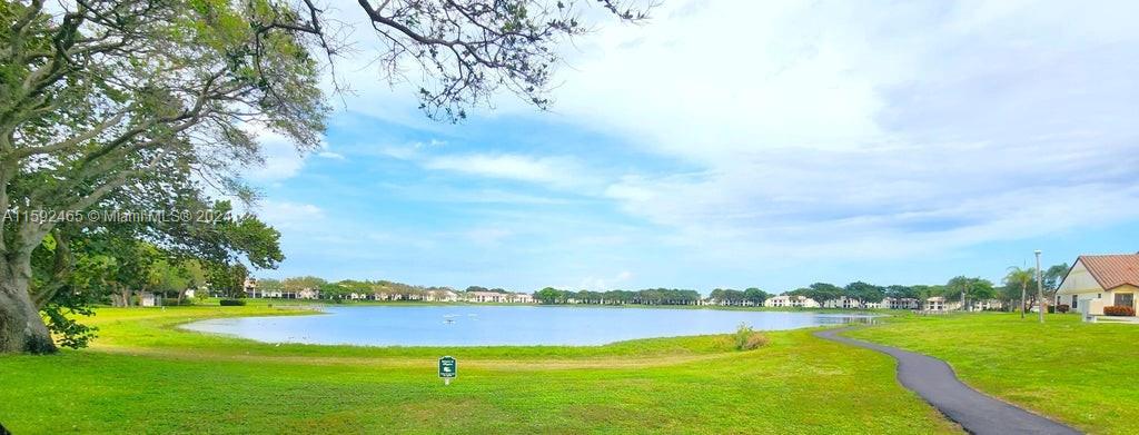 301 Olivewood Place, Unit O229 Boca Raton, FL 33431 - Photo 24 of 25 a view of a lake with houses in back
