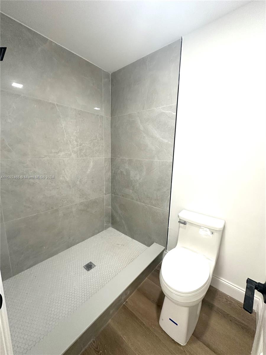 301 Olivewood Place, Unit O229 Boca Raton, FL 33431 - Photo 6 of 25 a bathroom with a toilet a sink and a shower