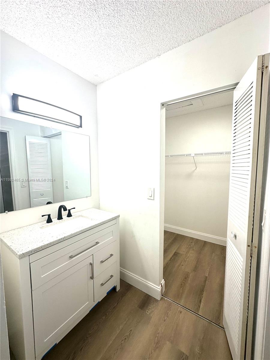 301 Olivewood Place, Unit O229 Boca Raton, FL 33431 - Photo 7 of 25 a bathroom with a sink and a mirror