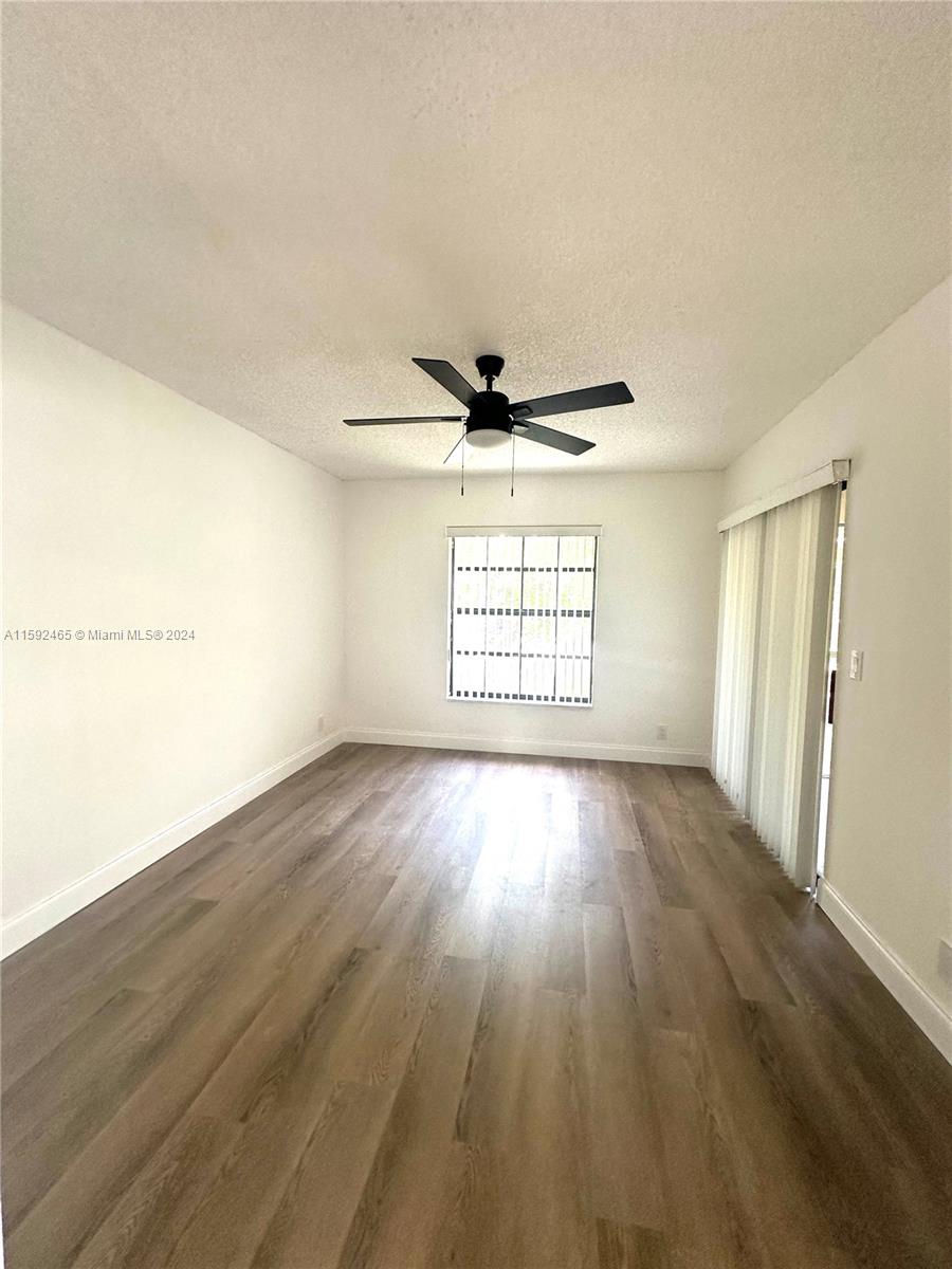 301 Olivewood Place, Unit O229 Boca Raton, FL 33431 - Photo 9 of 25 wooden floor in an empty room with a window