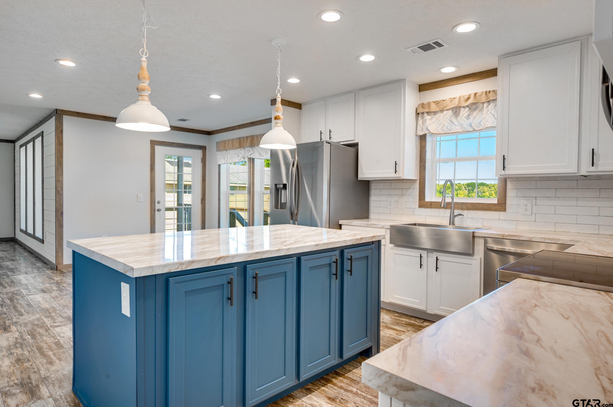 21903 Boles Road Frankston, TX 75763 - Photo 13 of 48 a kitchen with stainless steel appliances granite countertop a sink window and cabinets