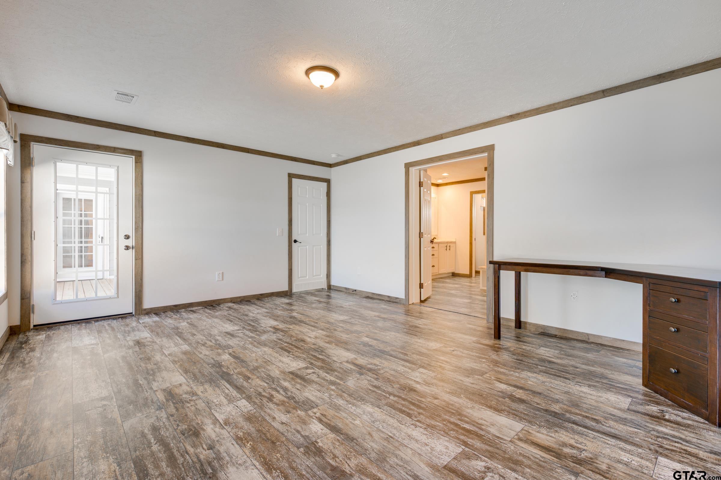 21903 Boles Road Frankston, TX 75763 - Photo 20 of 48 a view of an empty room with wooden floor and a window