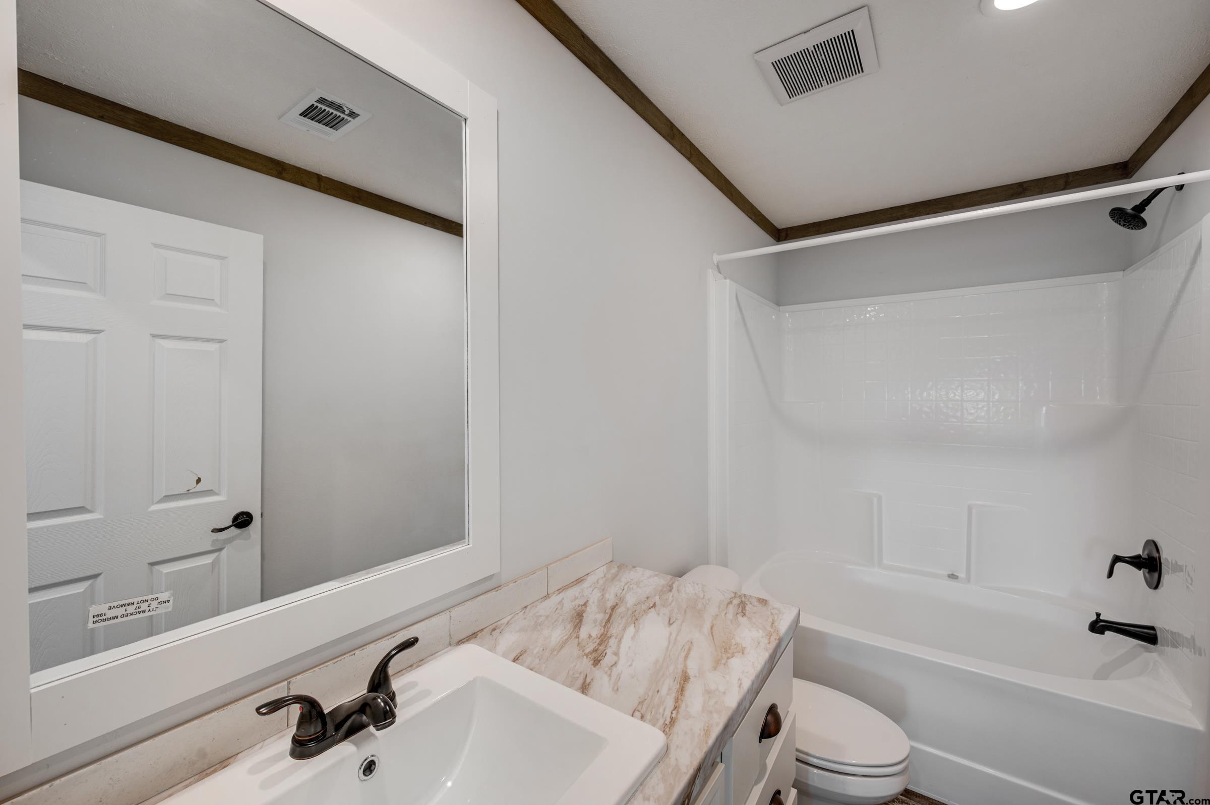 21903 Boles Road Frankston, TX 75763 - Photo 30 of 48 a bathroom with a sink a toilet and shower