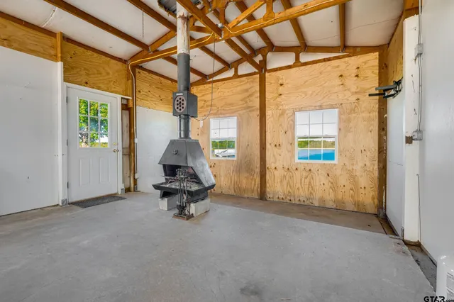 a view of a room with a window and hardwood floor