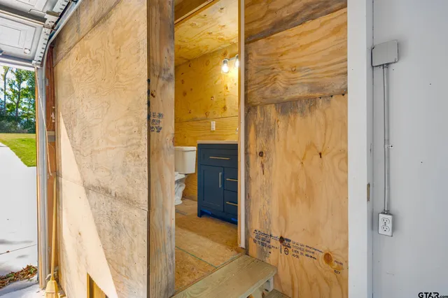 a bathroom with a glass shower door and a bathroom