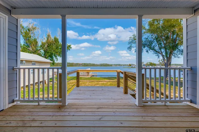 a view of a porch with a floor to ceiling window and wooden floor