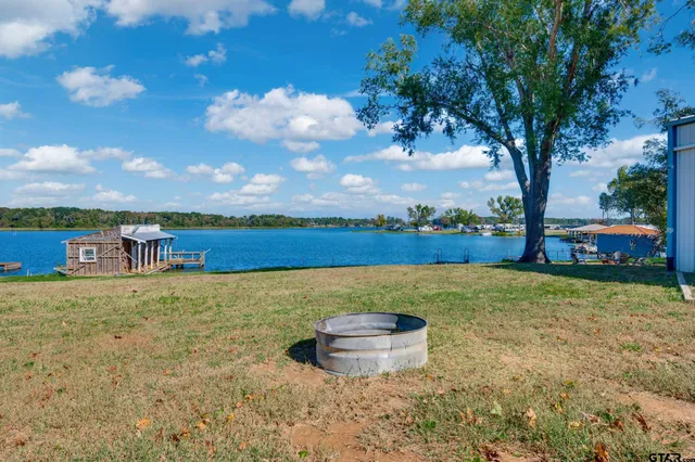 a view of a lake with houses in the back
