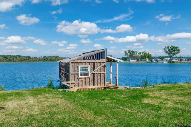 a view of a house with a backyard and lake view