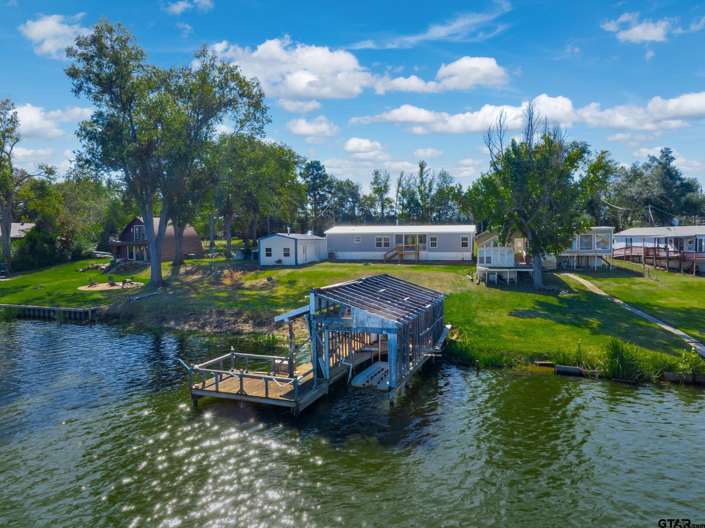 21903 Boles Road Frankston, TX 75763 - Photo 41 of 48 an aerial view of a house with swimming pool garden and lake view