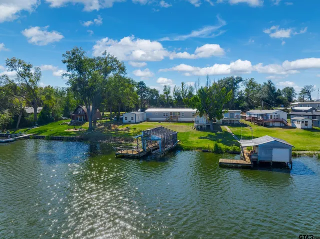 a view of a swimming pool with lawn chairs and a table
