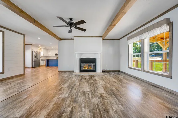 a view of kitchen with stainless steel appliances granite countertop a refrigerator and a sink