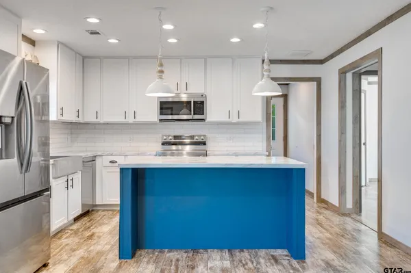 a living room with granite countertop furniture and a fireplace