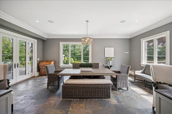 a living room with furniture and large windows