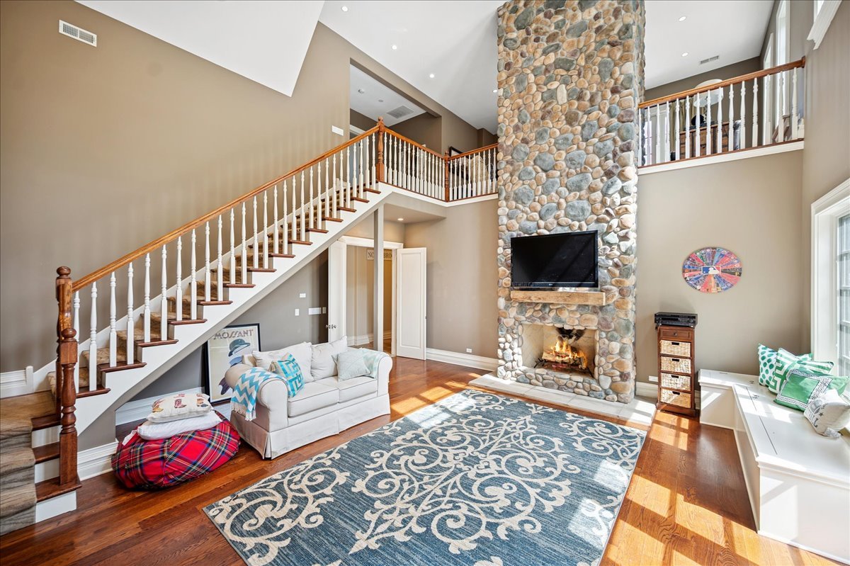 24 Bridlewood Road Northbrook, IL 60062 - Photo 20 of 56 a living room with fireplace furniture and a flat screen tv