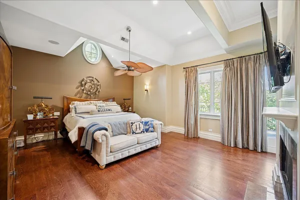 a bedroom with furniture wooden floor and a fireplace