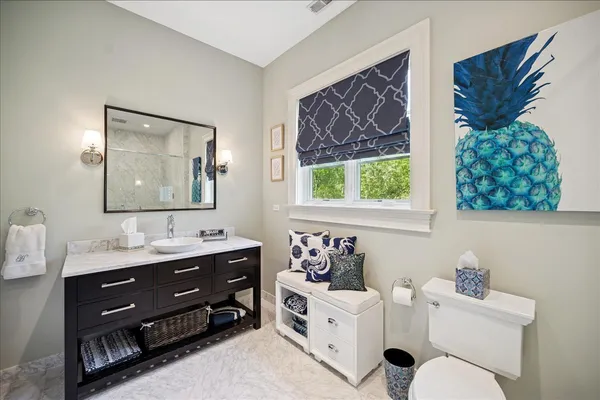a bathroom with a granite countertop sink mirror bathtub and double