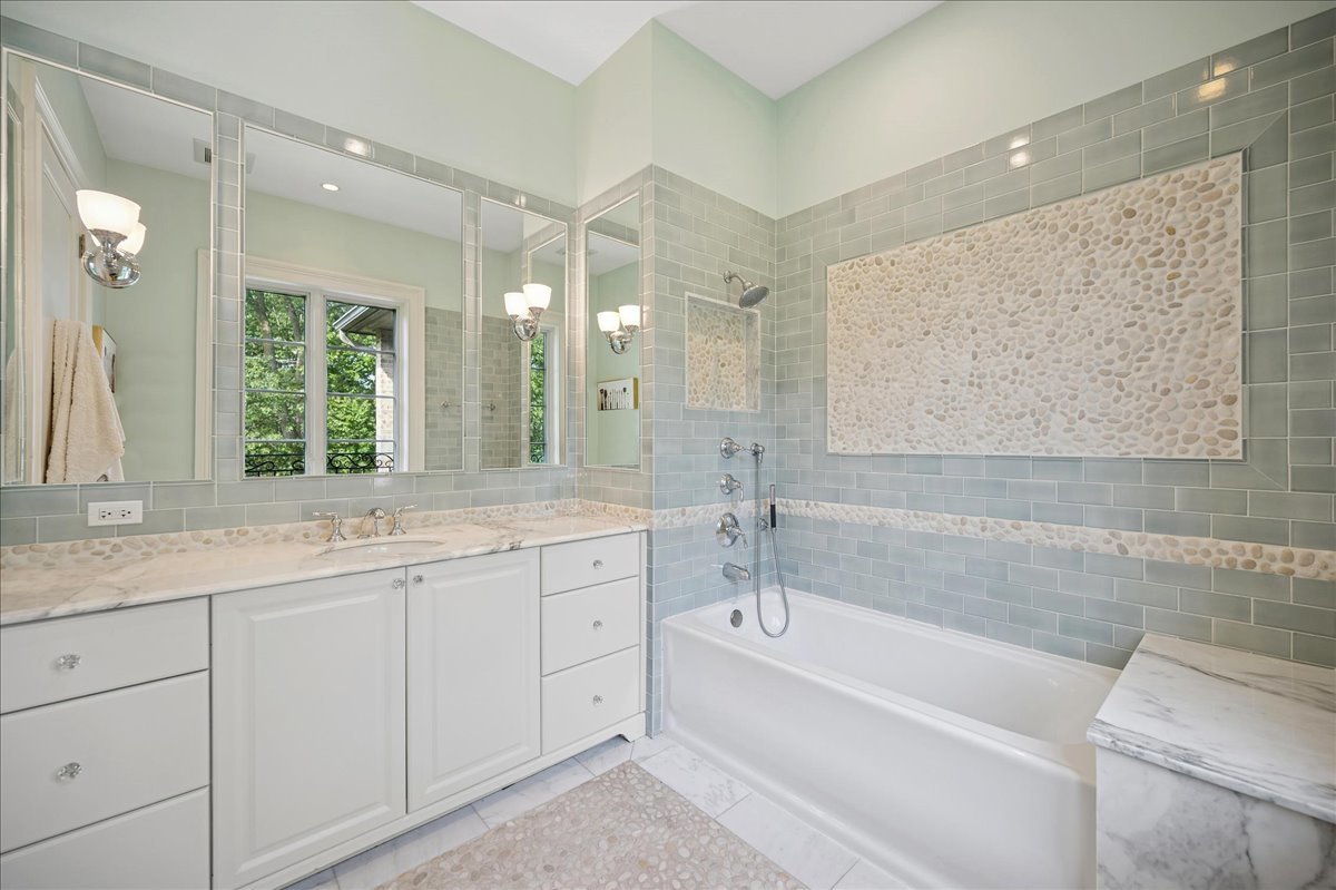 24 Bridlewood Road Northbrook, IL 60062 - Photo 34 of 56 a bathroom with a granite countertop sink mirror bathtub and double
