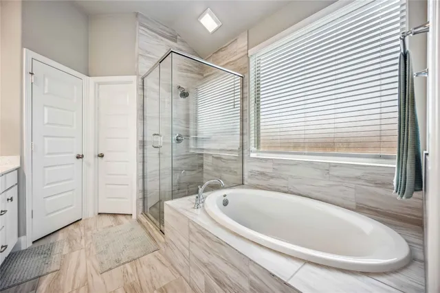 a bathroom with a bathtub and a shower