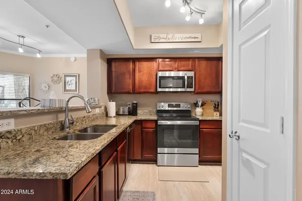 a kitchen with stainless steel appliances granite countertop a stove and a sink