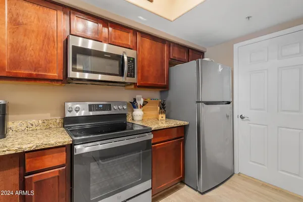a kitchen with a refrigerator stove and microwave